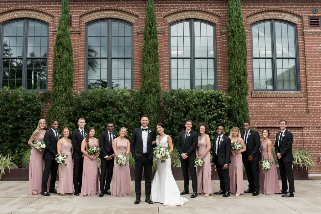 wedding party pose in courtyard of Cedar Room