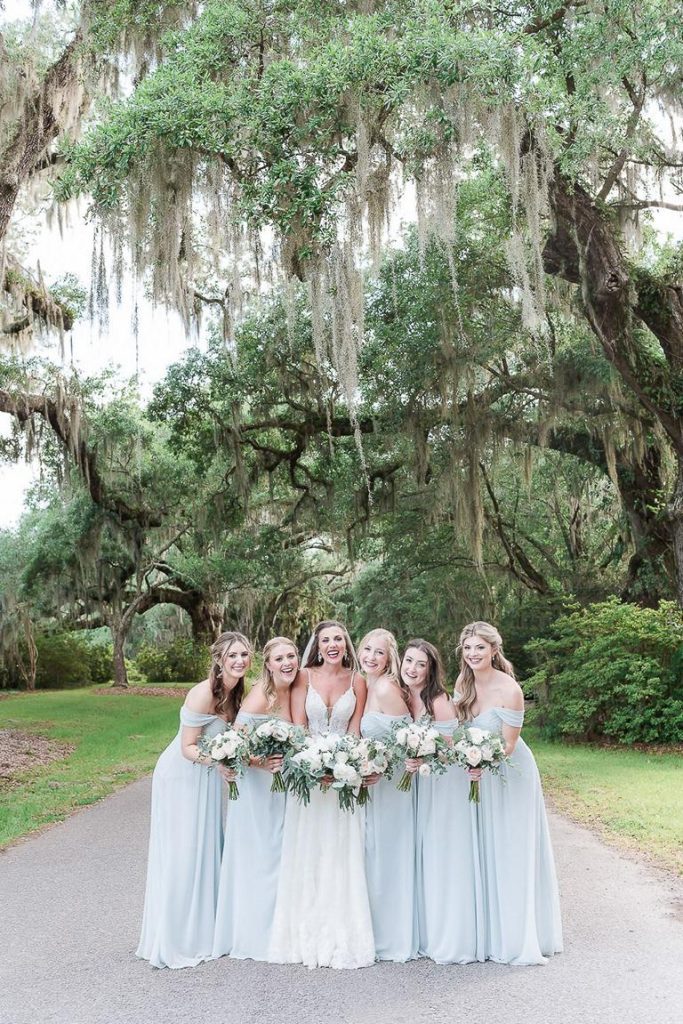 bridal party pose under avenue of oaks