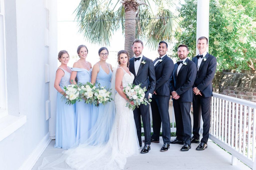 Wedding Party on porch of Gadsden House, men in black tuxes women in pale blue dresses