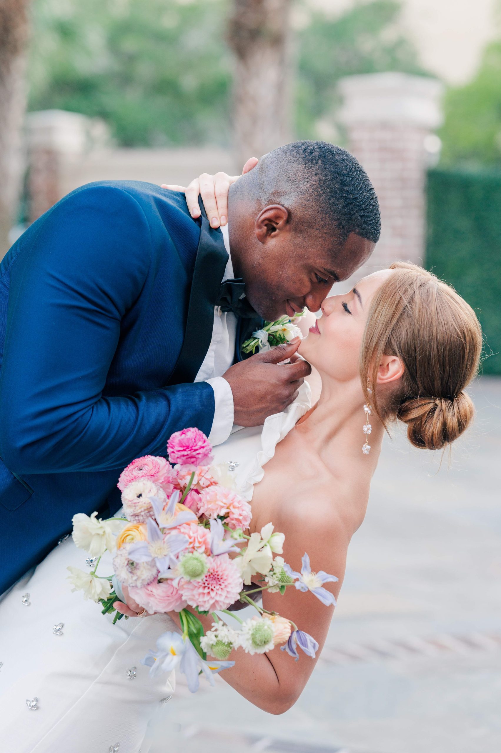 groom holding bride's chin up in a dip