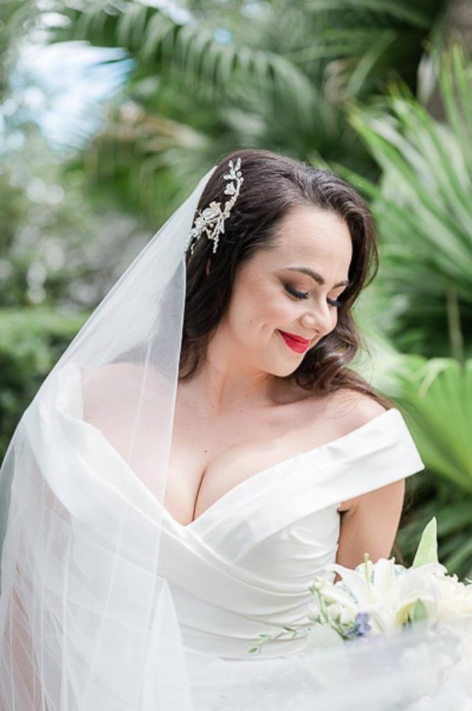 Closeup of bride looking down at her flowers