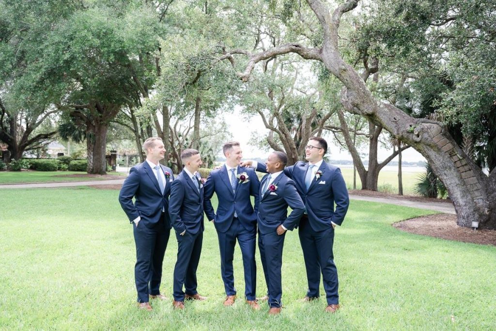 Groom and Groomsmen joking around outside
