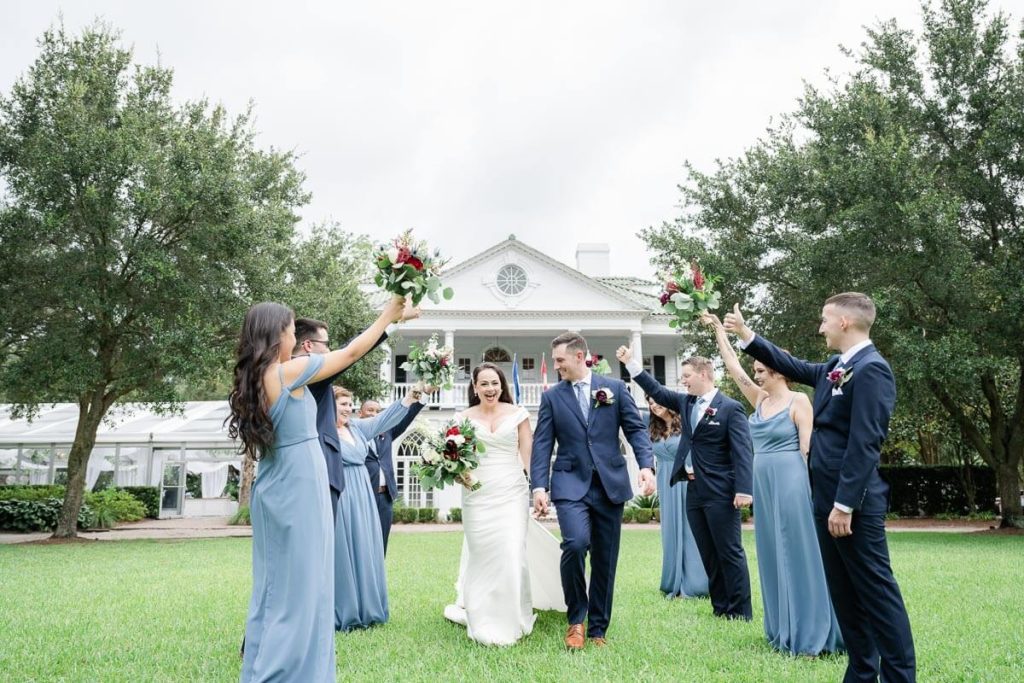 Newlyweds run through cheering tunnel of wedding party