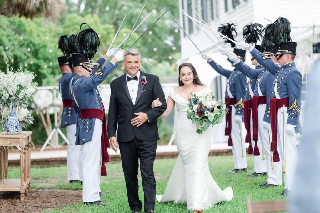 Bride and Father enter ceremony under Citadel Sword Arch