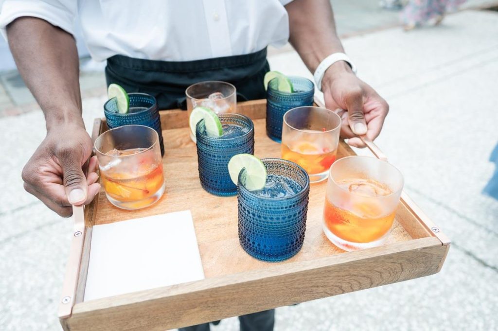 wooden tray of cocktails at wedding reception