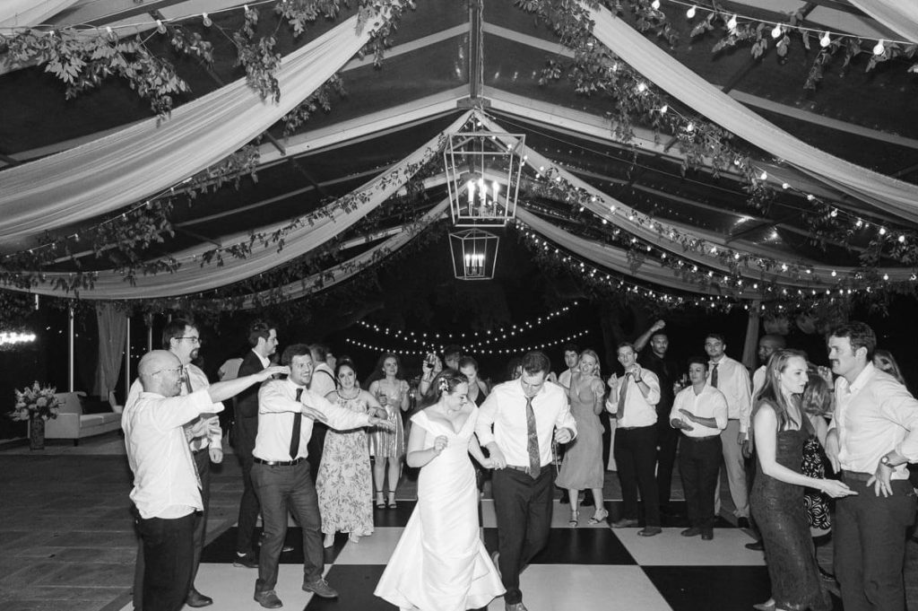 newlyweds dance at wedding reception on checked floor