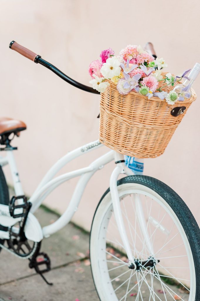 bicycle with basket filled with wine and flowers