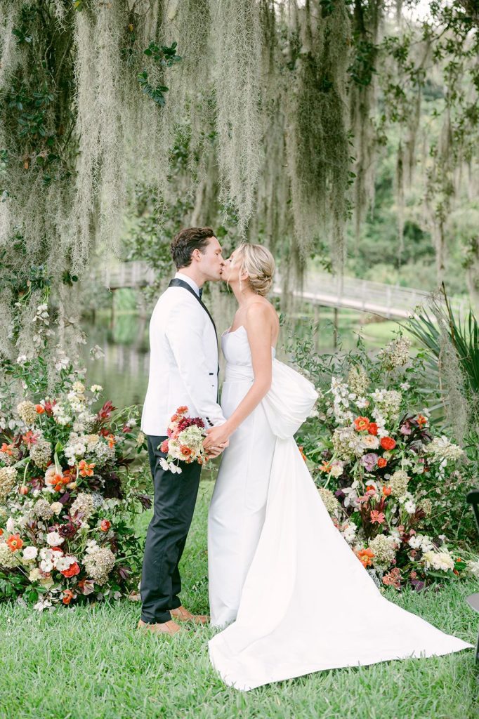 wedding ceremony in gardens surrounded by flowers