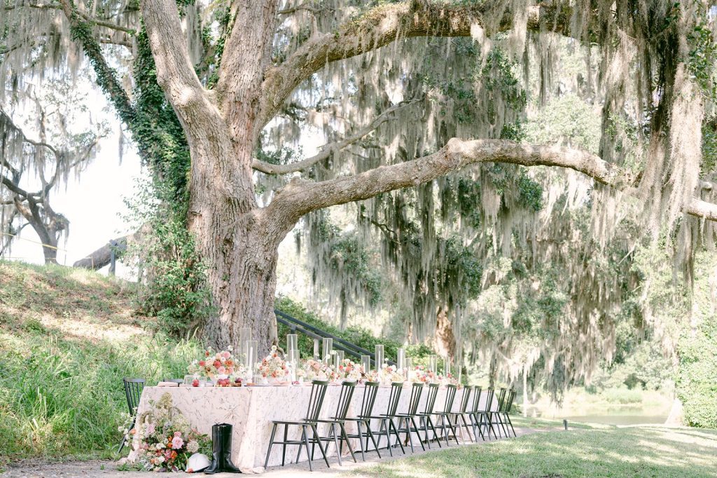 long table with black chairs set up alfresco