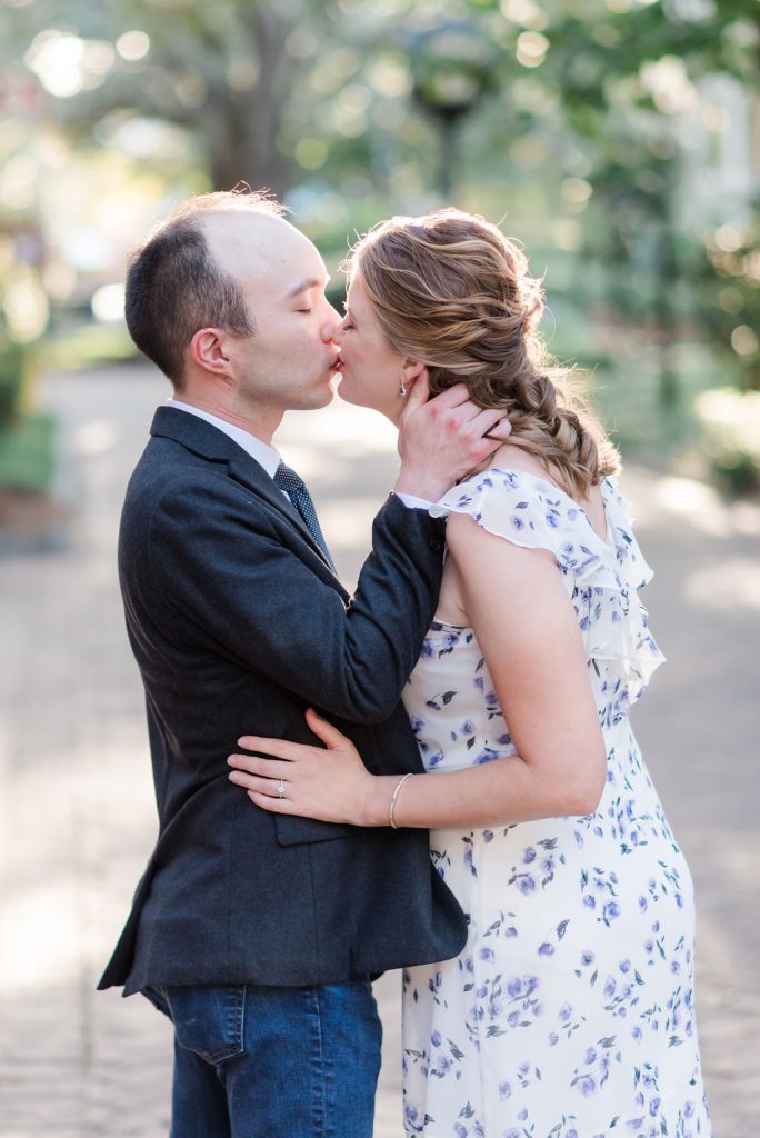 engaged couple kisses on College of Charleston campus