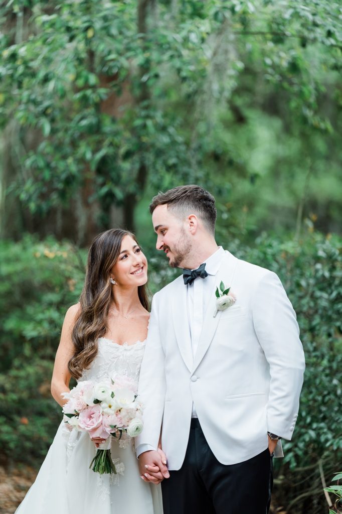 bride and groom have first look and holds hands