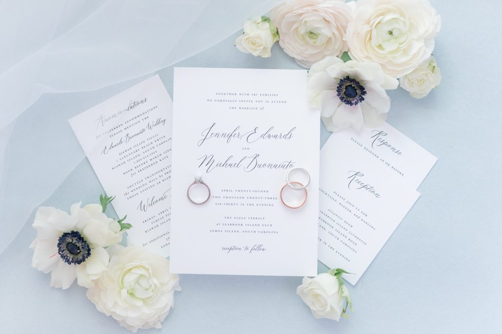 classic wedding invitation flat lay on blue background