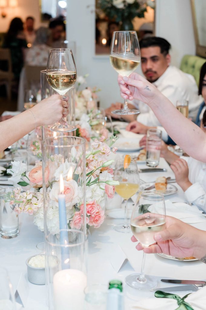 guests toast speech with white wine at wedding reception