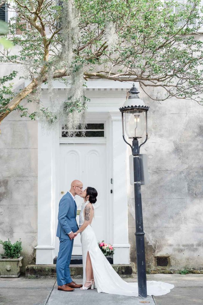 newlyweds kiss in front of door on Chalmers Street