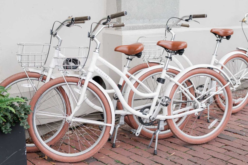 bunch of bicycles leaned against Hotel Emeline