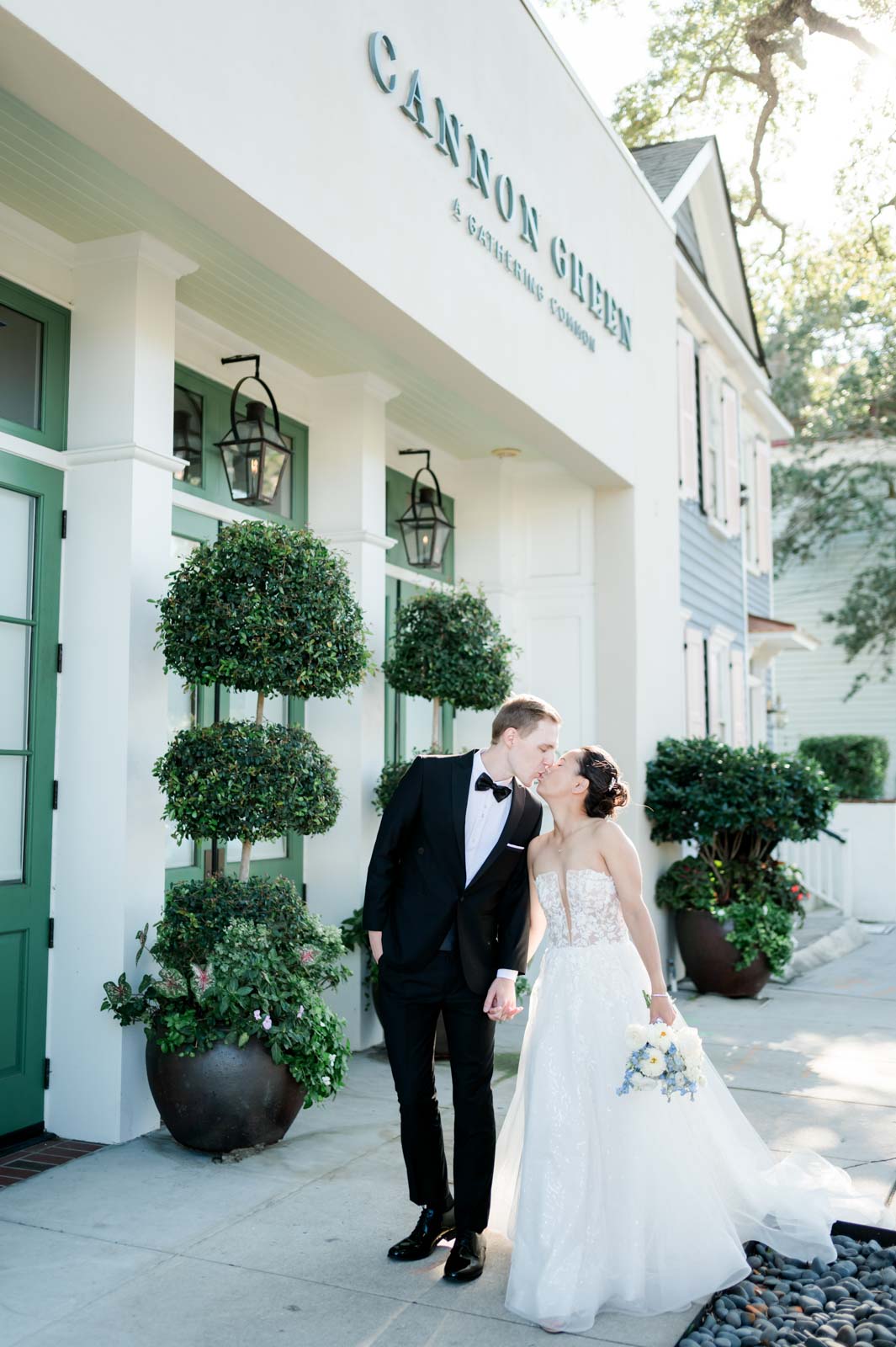 newlyweds kiss in front of Cannon Green wedding venue
