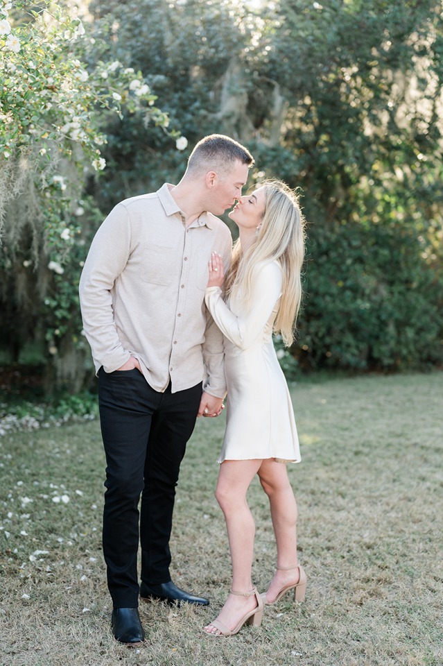 Engaged couple kiss at park