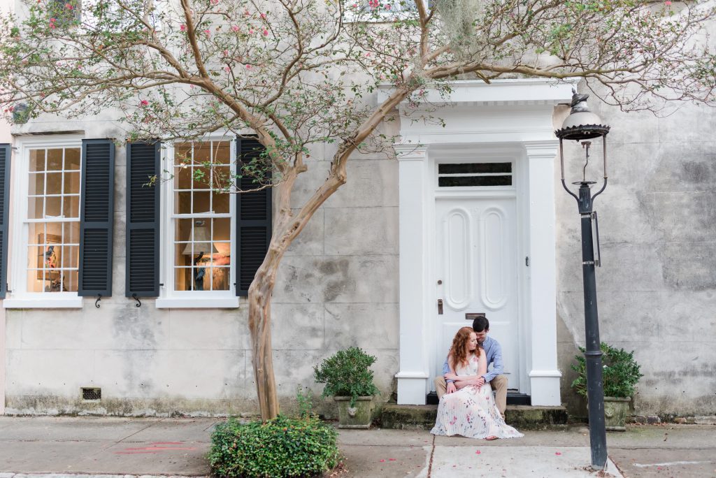 engaged couple sit on doorstep on Chalmers Street