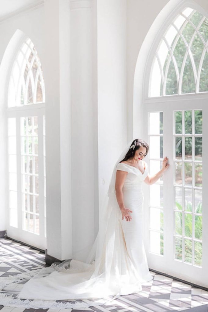 Full length bridal portrait inside portico of Lowndes Grove Plantation