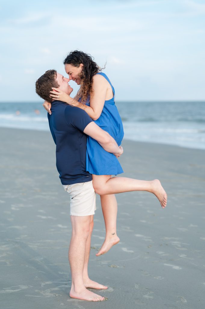 guy lifting up girlfriend after she has agreed to marry him.
