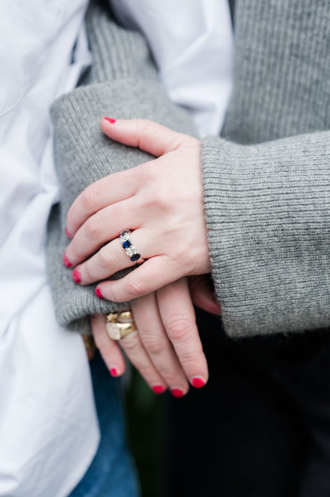 engaged couple's hand on tops of each other